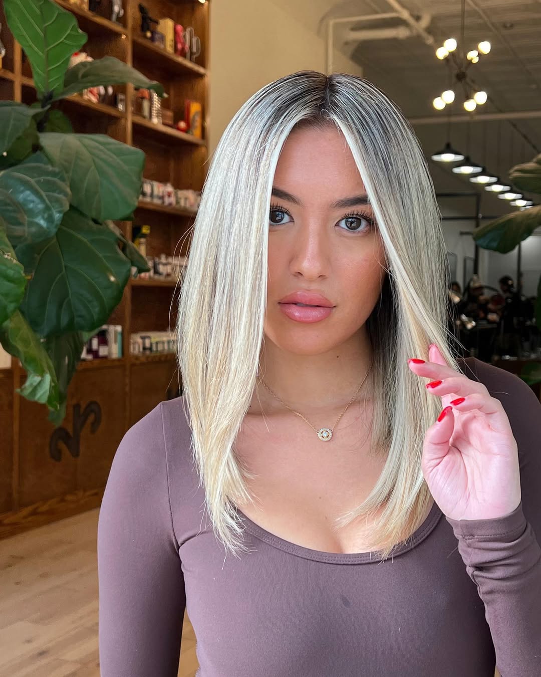 Sleek Platinum Blonde Mid-Length Cut With Shadow Root