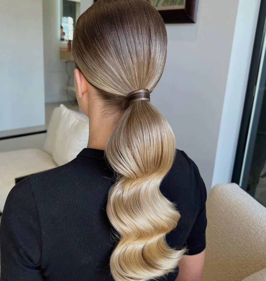 Sleek Wavy Ponytail With Voluminous Curls