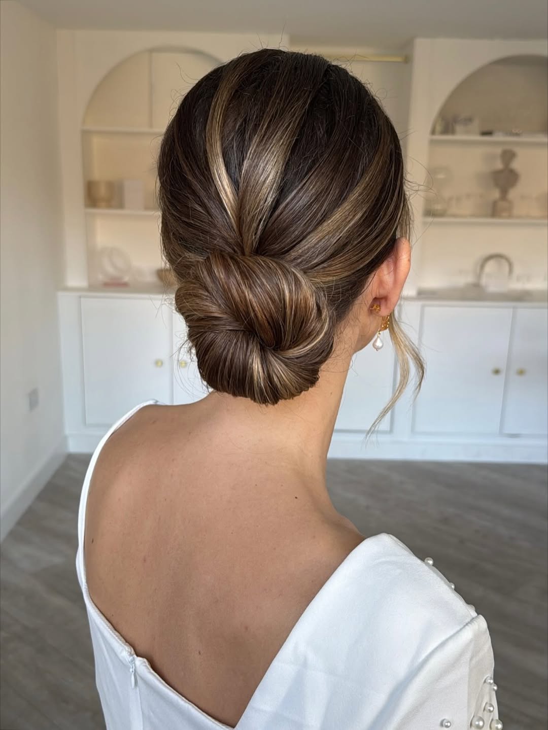 Sophisticated Low Bun With Caramel Highlights