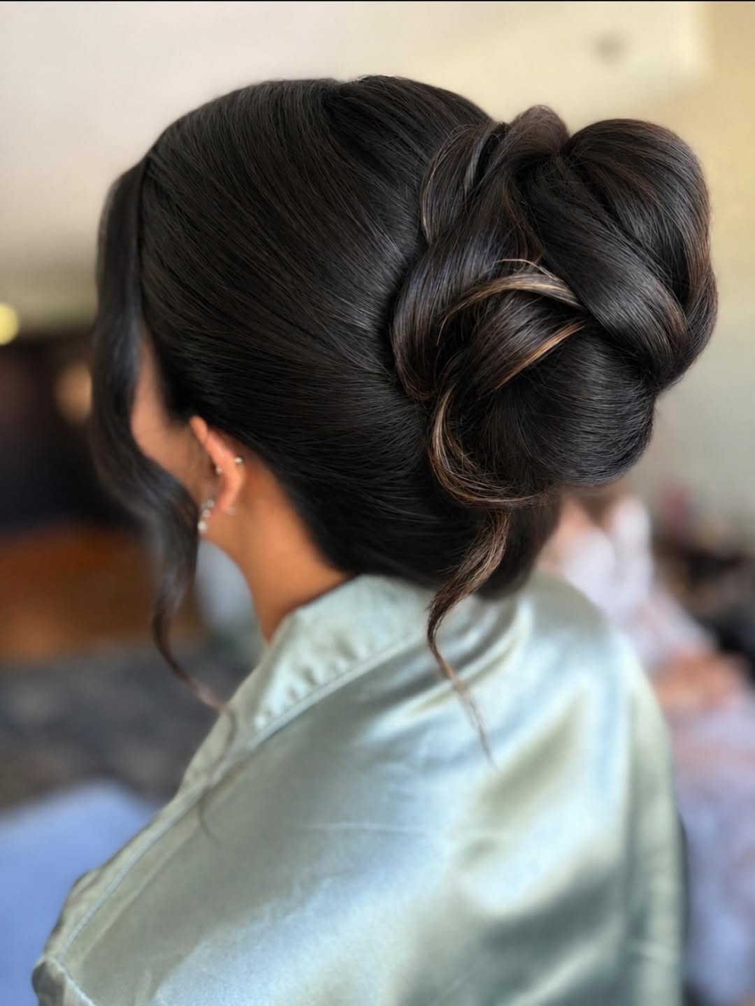 Sophisticated Low Bun With Face Framing Waves