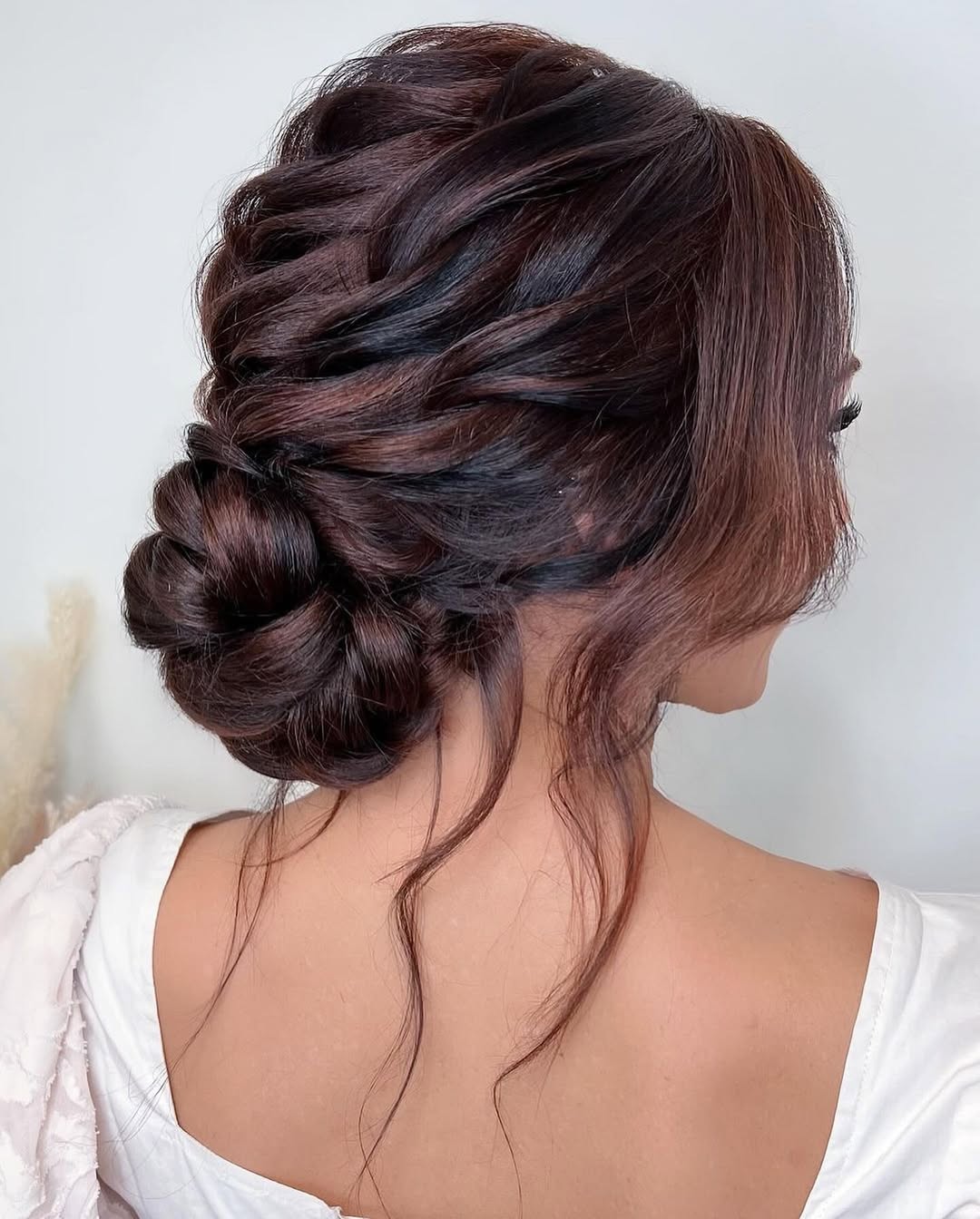 Sophisticated Twisted Low Bun With Face-Framing Tendrils