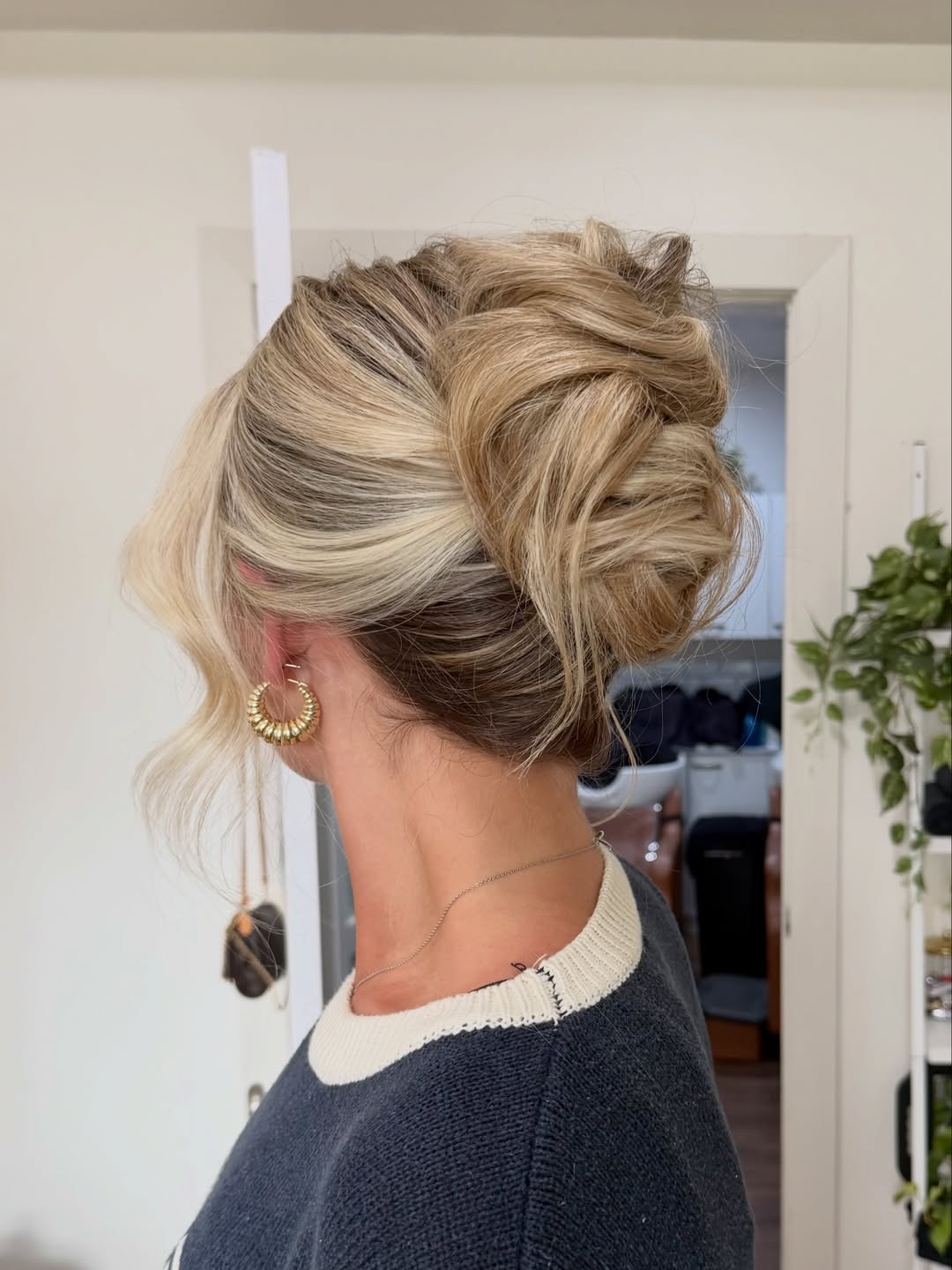 Textured Blonde Low Bun With Face-Framing Waves