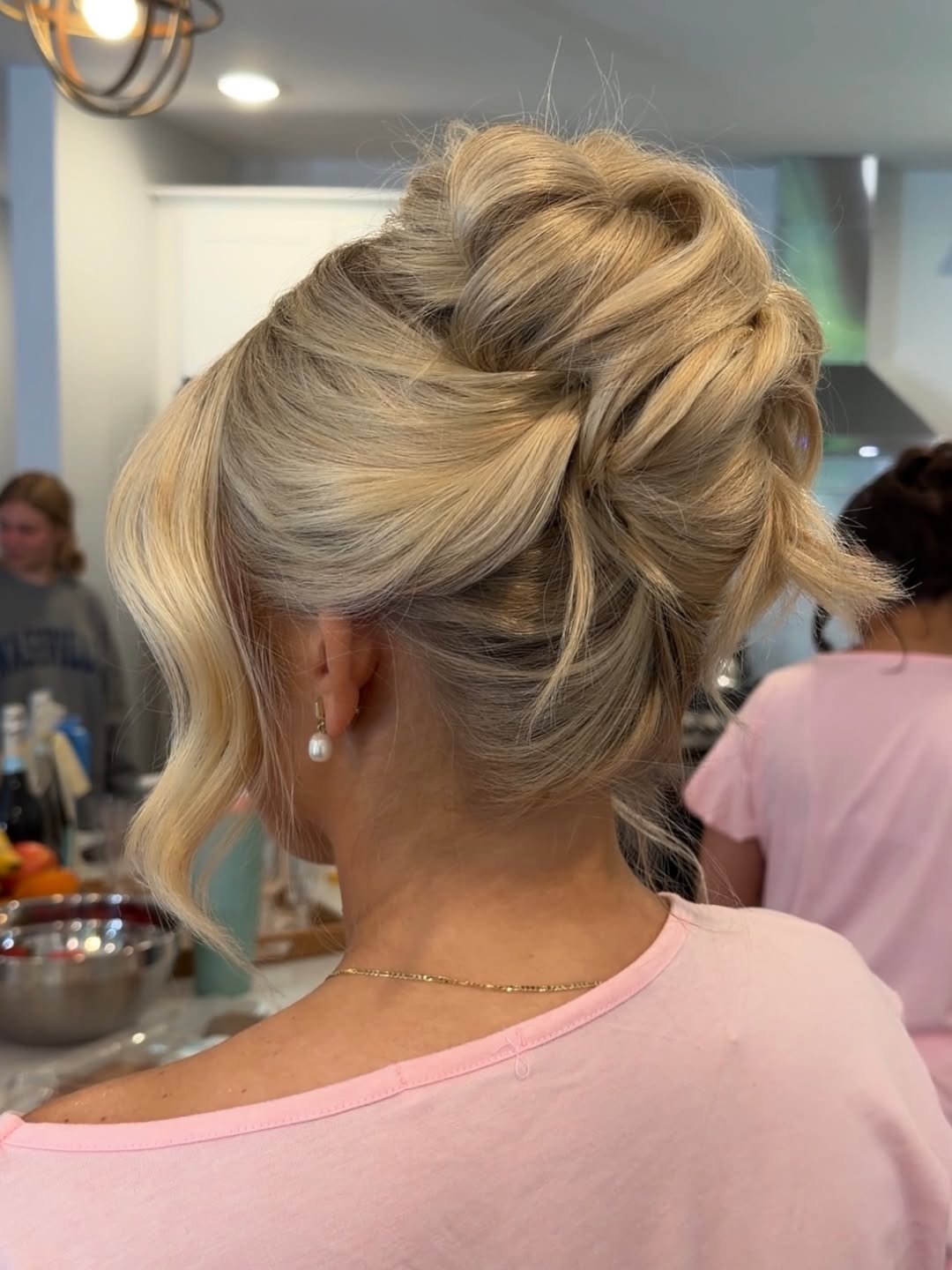 Textured Blonde Updo with Face-Framing Waves