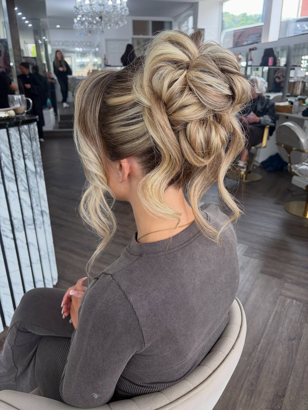 Textured High Updo With Face-Framing Tendrils