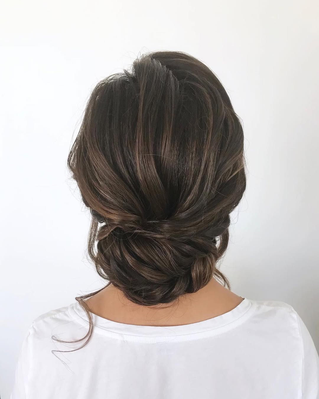 Textured Low Bun With Face-Framing Tendrils