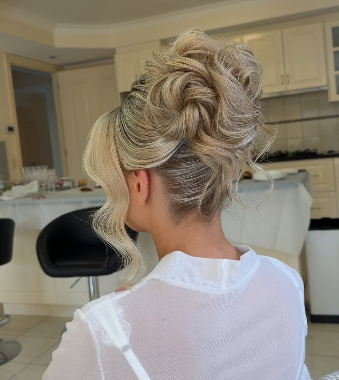 Textured Platinum Blonde Updo With Face-Framing Tendrils