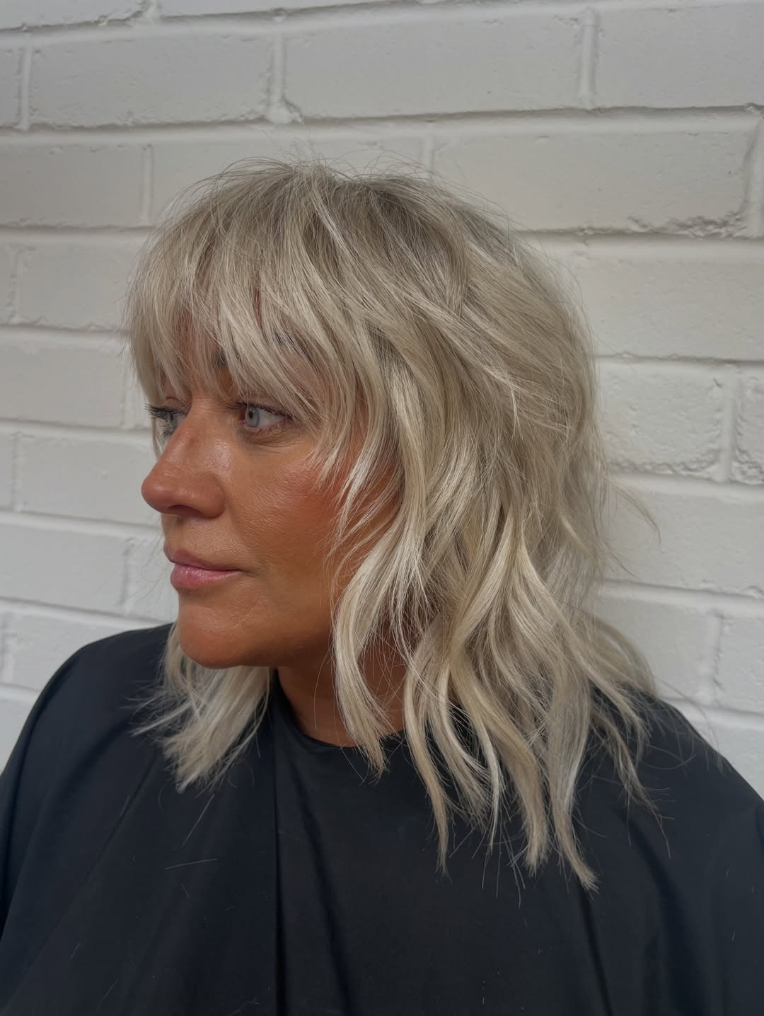 Tousled Platinum Blonde Wolf Cut With Wispy Bangs