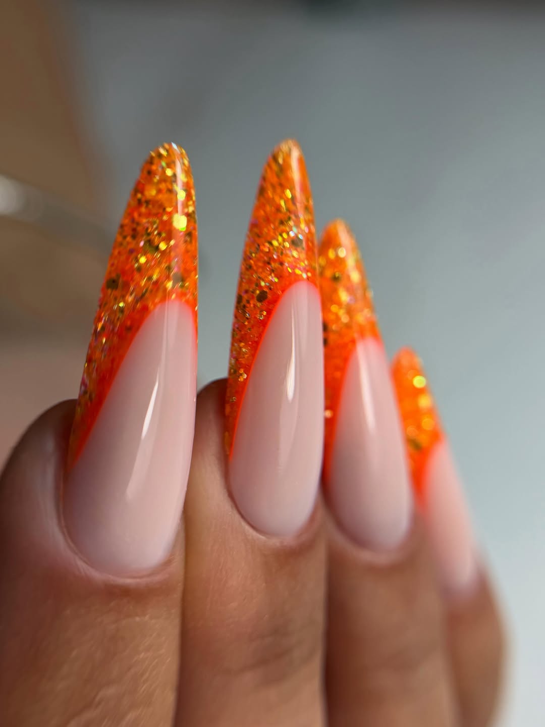 Vibrant Orange Glitter French Tip Stiletto Nails