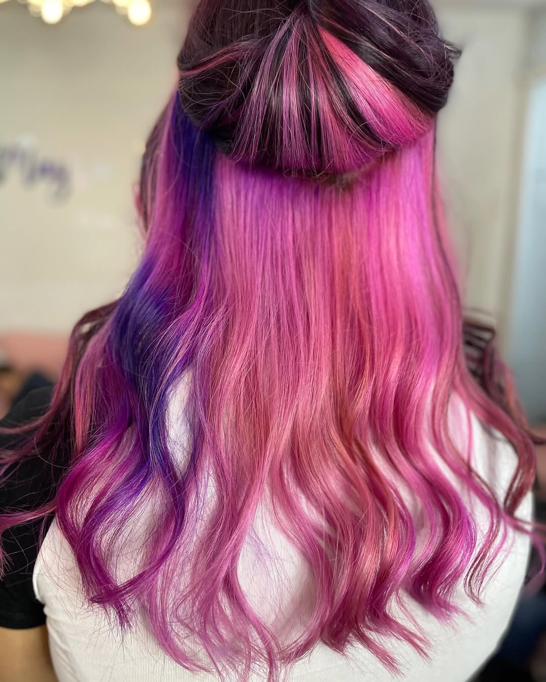 Vibrant Pink And Purple Peekaboo Hair With Soft Waves