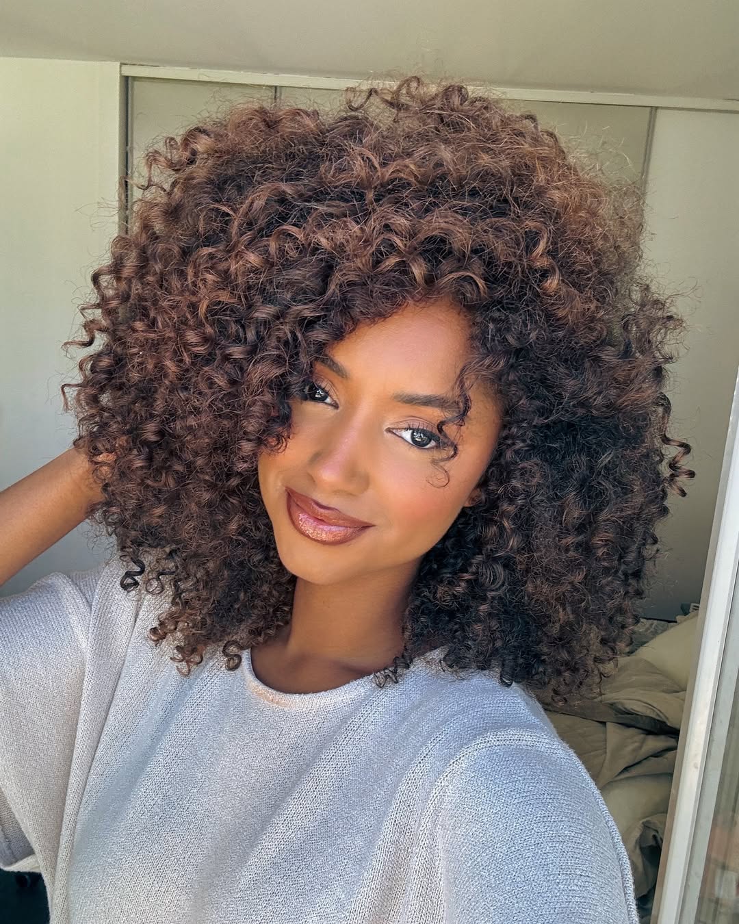 Voluminous Auburn Curls With Golden Highlights