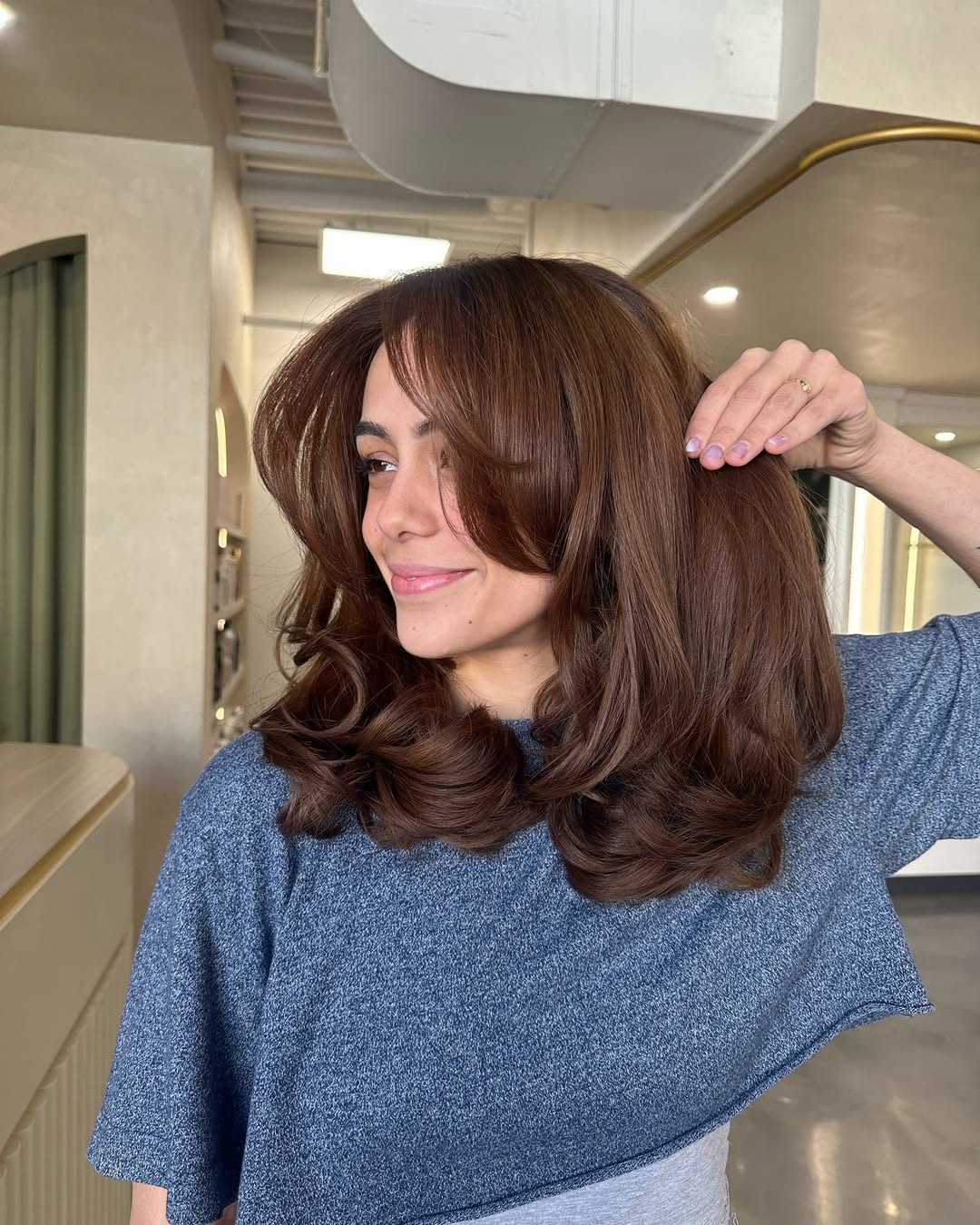 Voluminous Chestnut Layers With Face-Framing Bangs