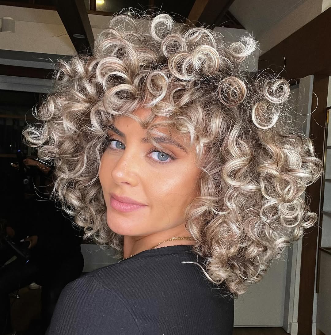 Voluminous Platinum Blonde Bob With Curly Bangs