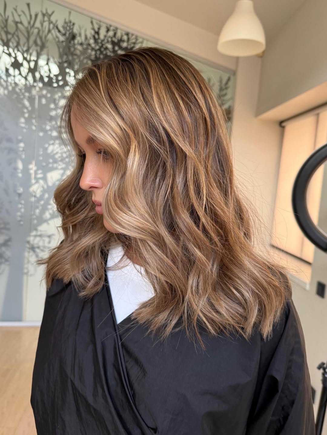 Warm Blonde Balayage With Face Framing Waves