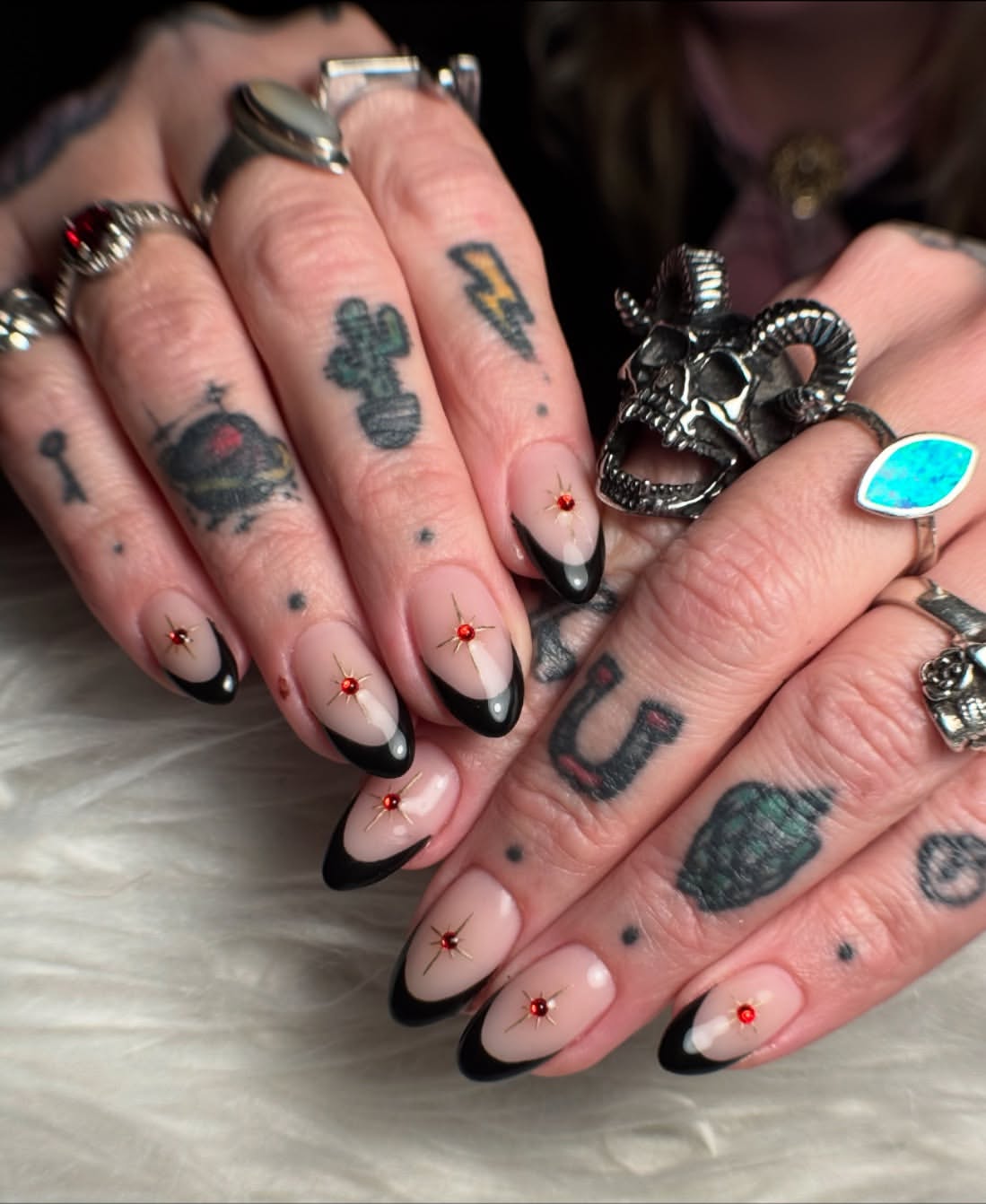 Black French Tip Oval Nails with Starburst Gems