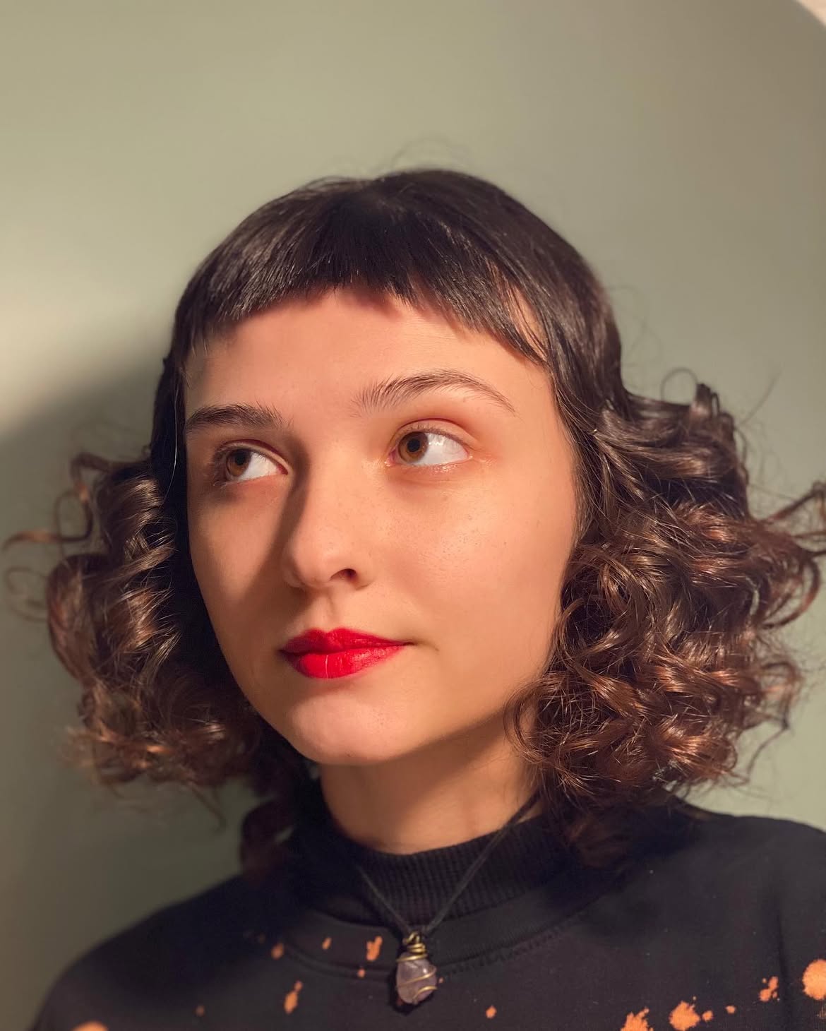 Bold Micro Bangs With Voluminous Curls