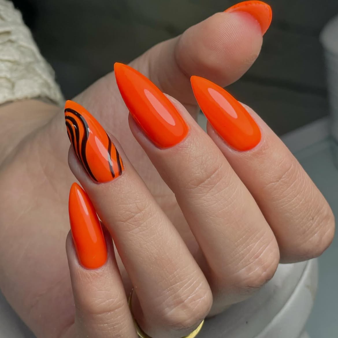 Bold Orange Stiletto Nails With Black Tiger Stripes