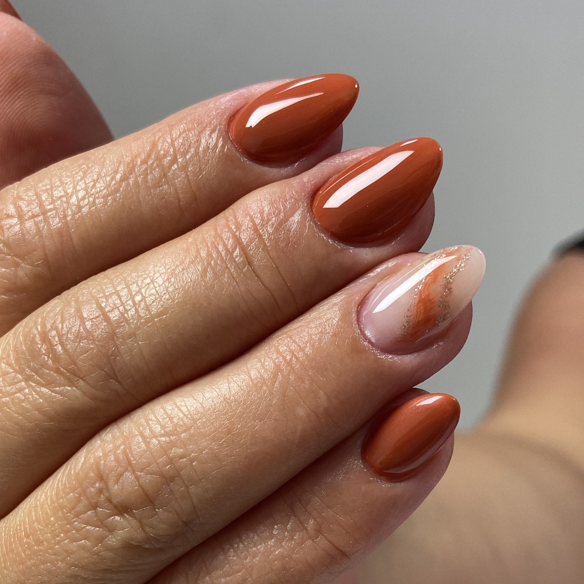 28 Stunning Orange Fall Nail Ideas You Need to Try 24 Burnt Orange Swirl Almond Nails with Glitter Accent