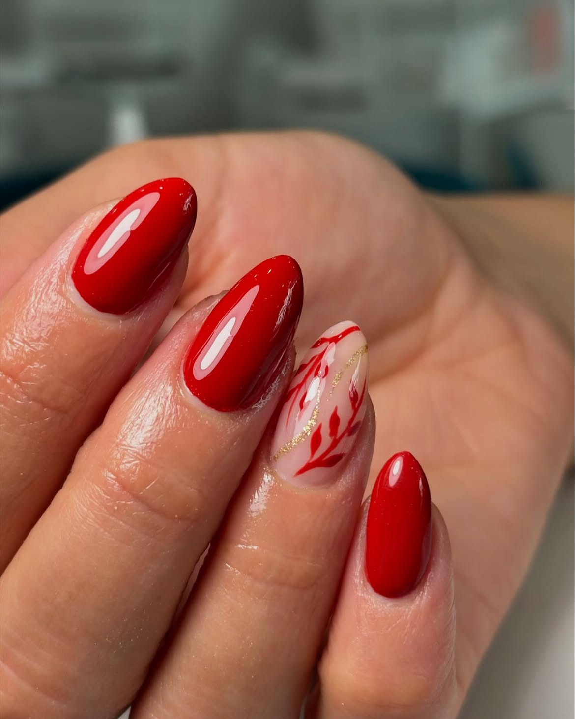 Chic Red Oval Nails with Gold Leaf Art