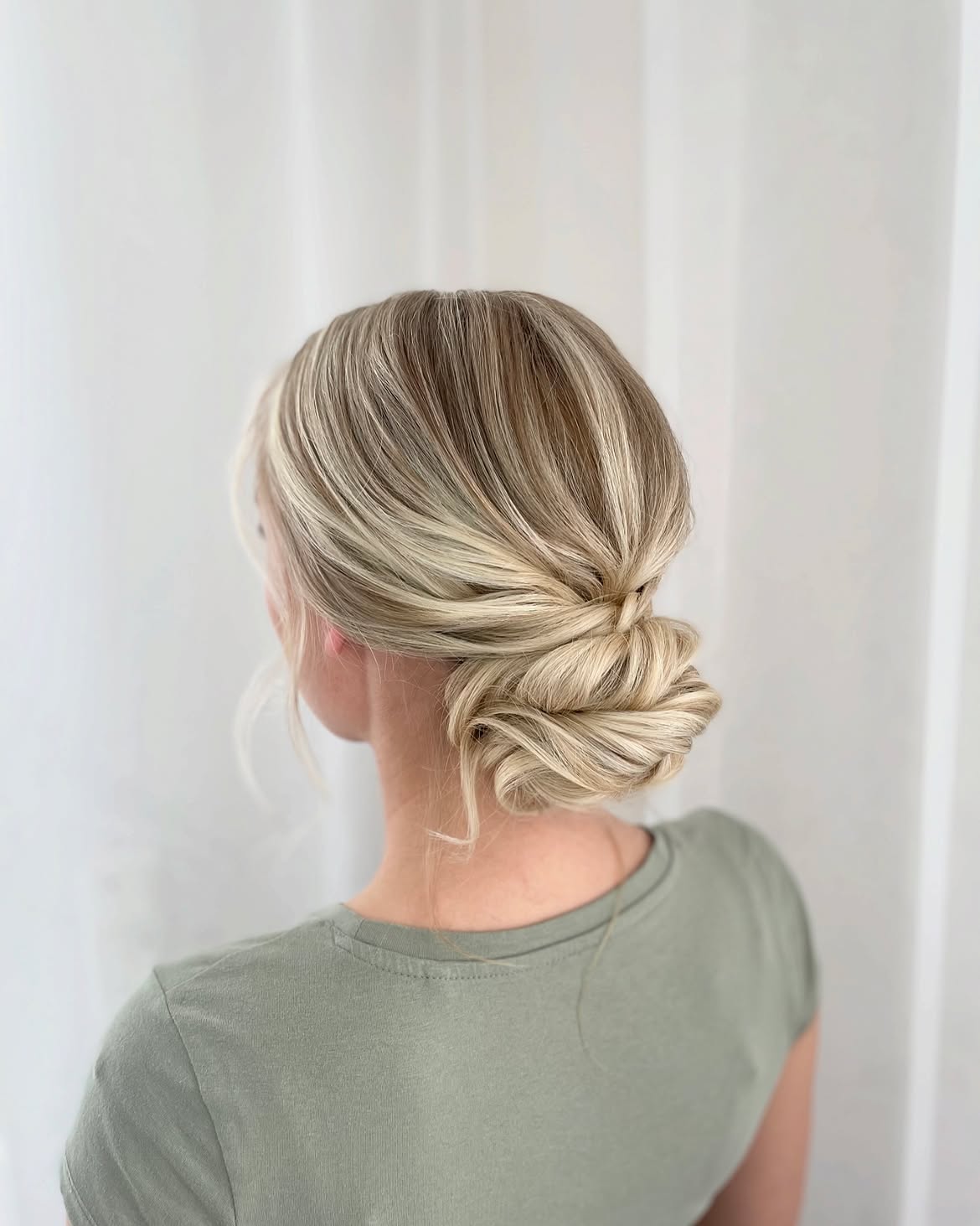Chic Twisted Low Bun With Honey Blonde Highlights