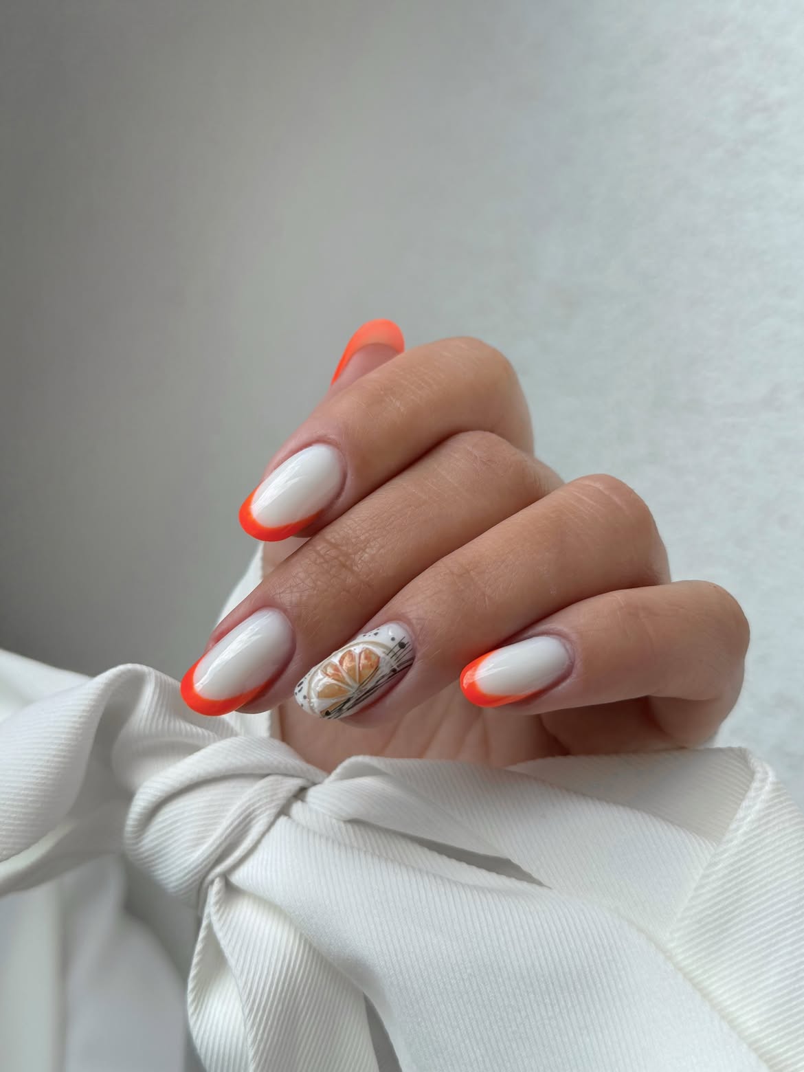 Coral French Tips with Citrus Nail Art Accent