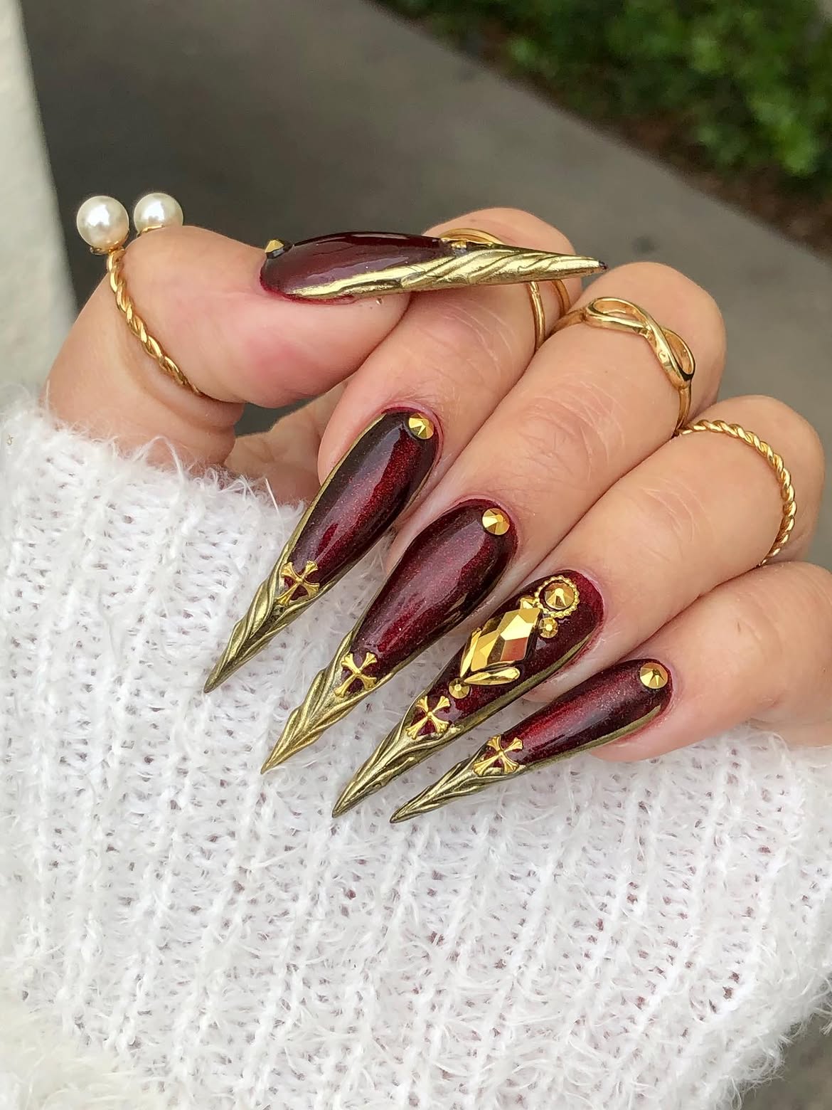 Dark Cherry Stiletto Nails With Gold Embellishments