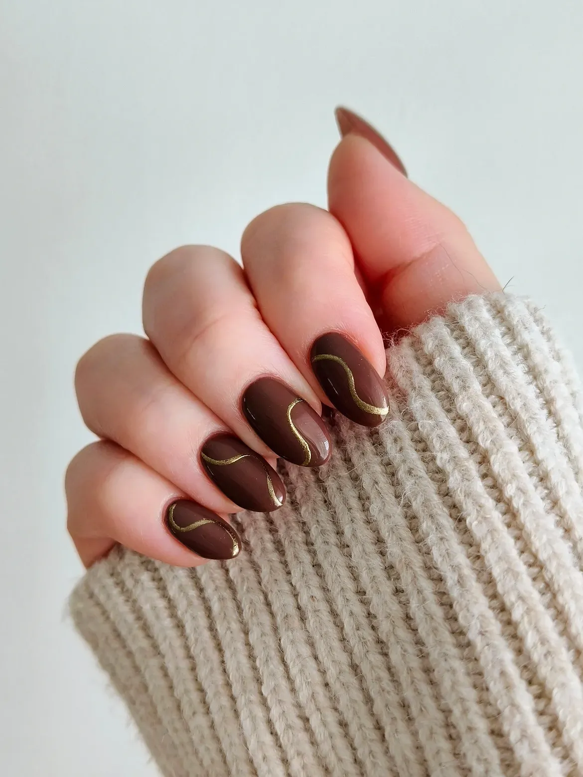Deep Chocolate Swirls With Gold Almond Nails