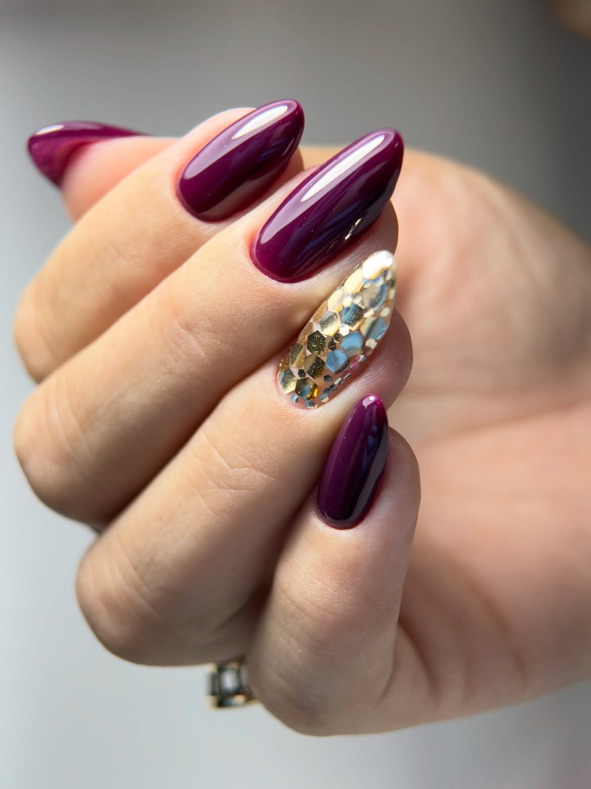 Deep Plum Glossy Almond Nails with Gold Accent