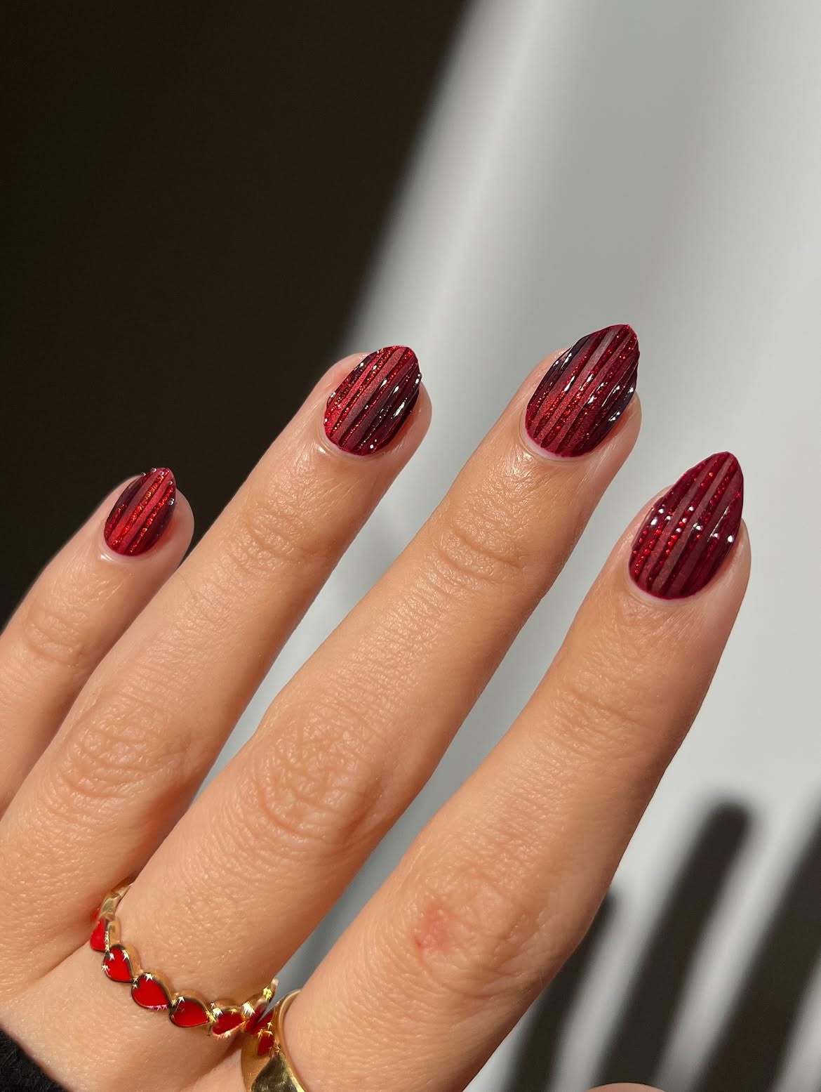 Deep Red Glitter Striped Almond Nails