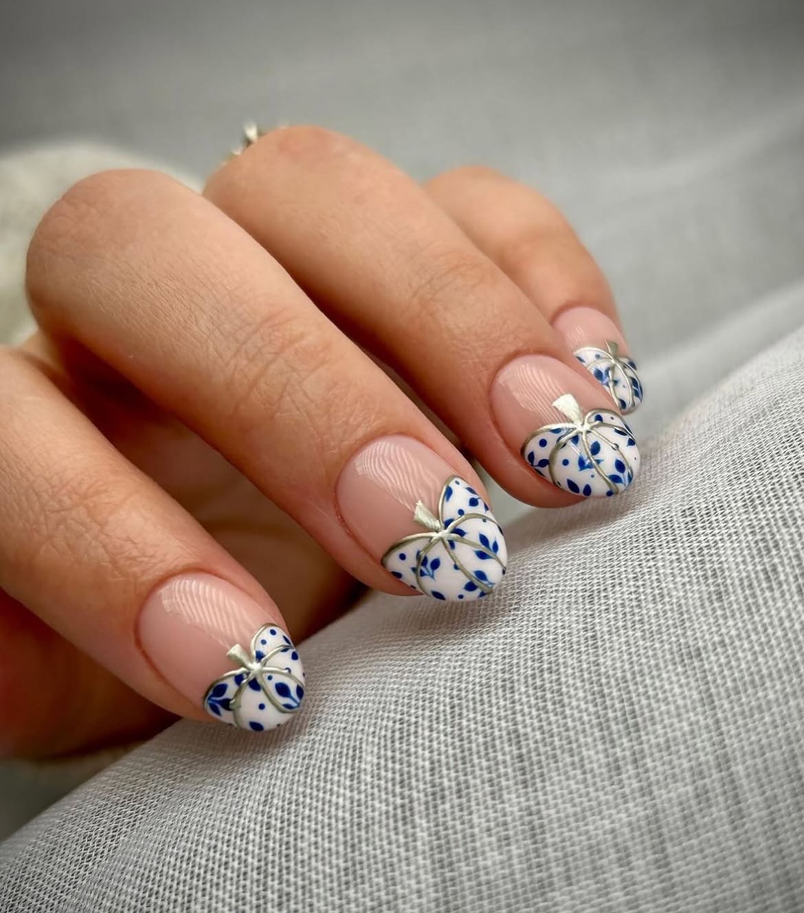 28 Stunning Pumpkin Nail Ideas for a Chic Fall Look 9 Delicate Blue & White Pumpkin French Tip Nails