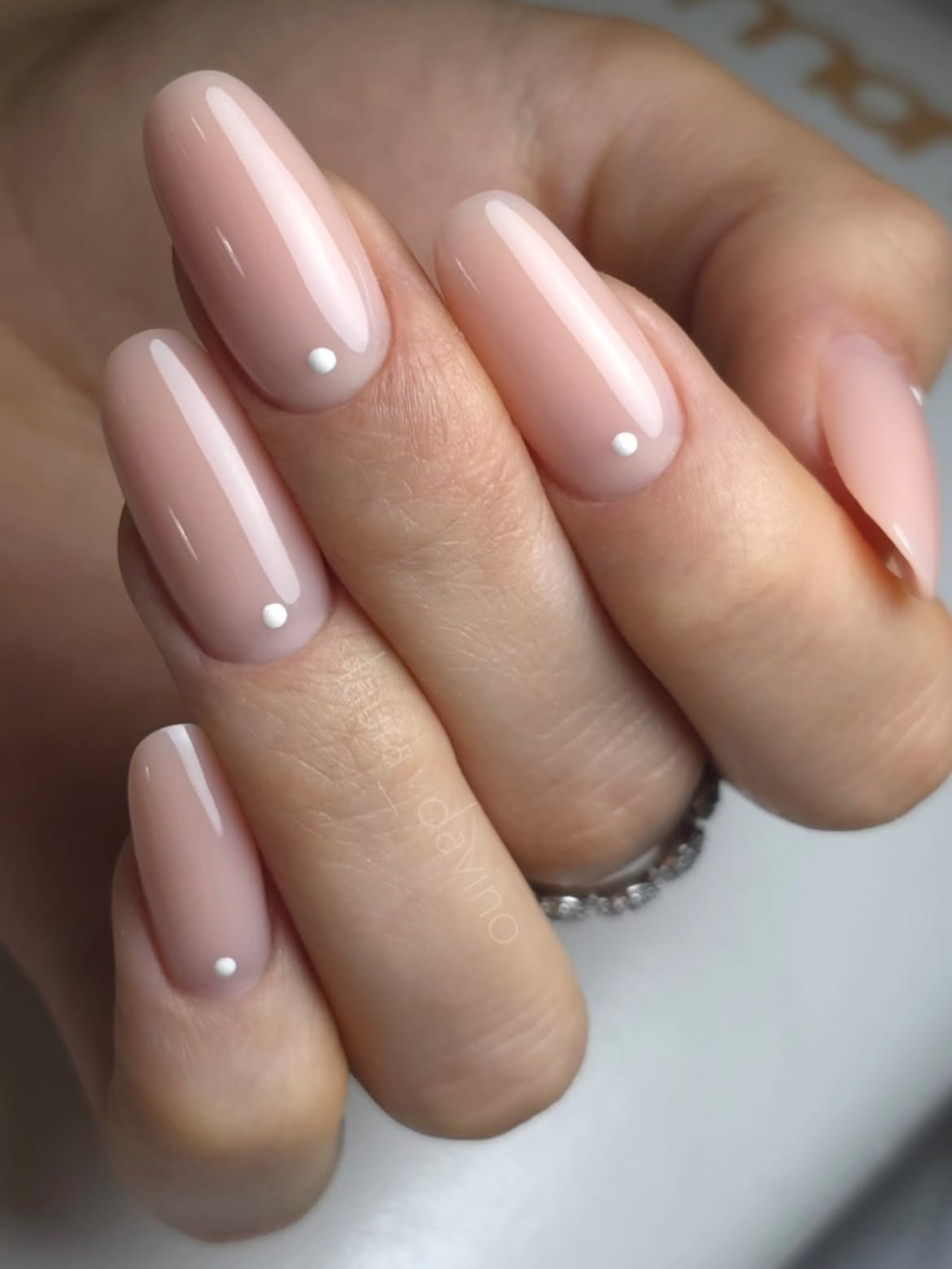 Delicate Nude Oval Nails with Tiny White Dots