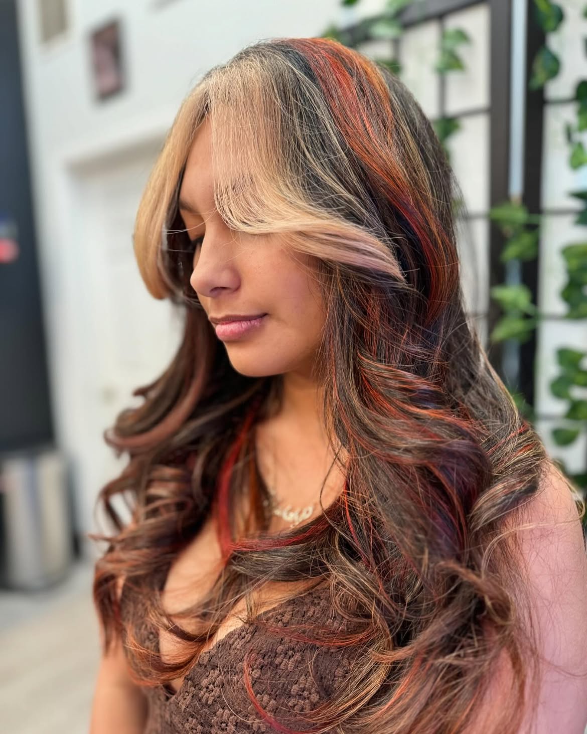 Fiery Copper Streaks On Face-Framing Blonde