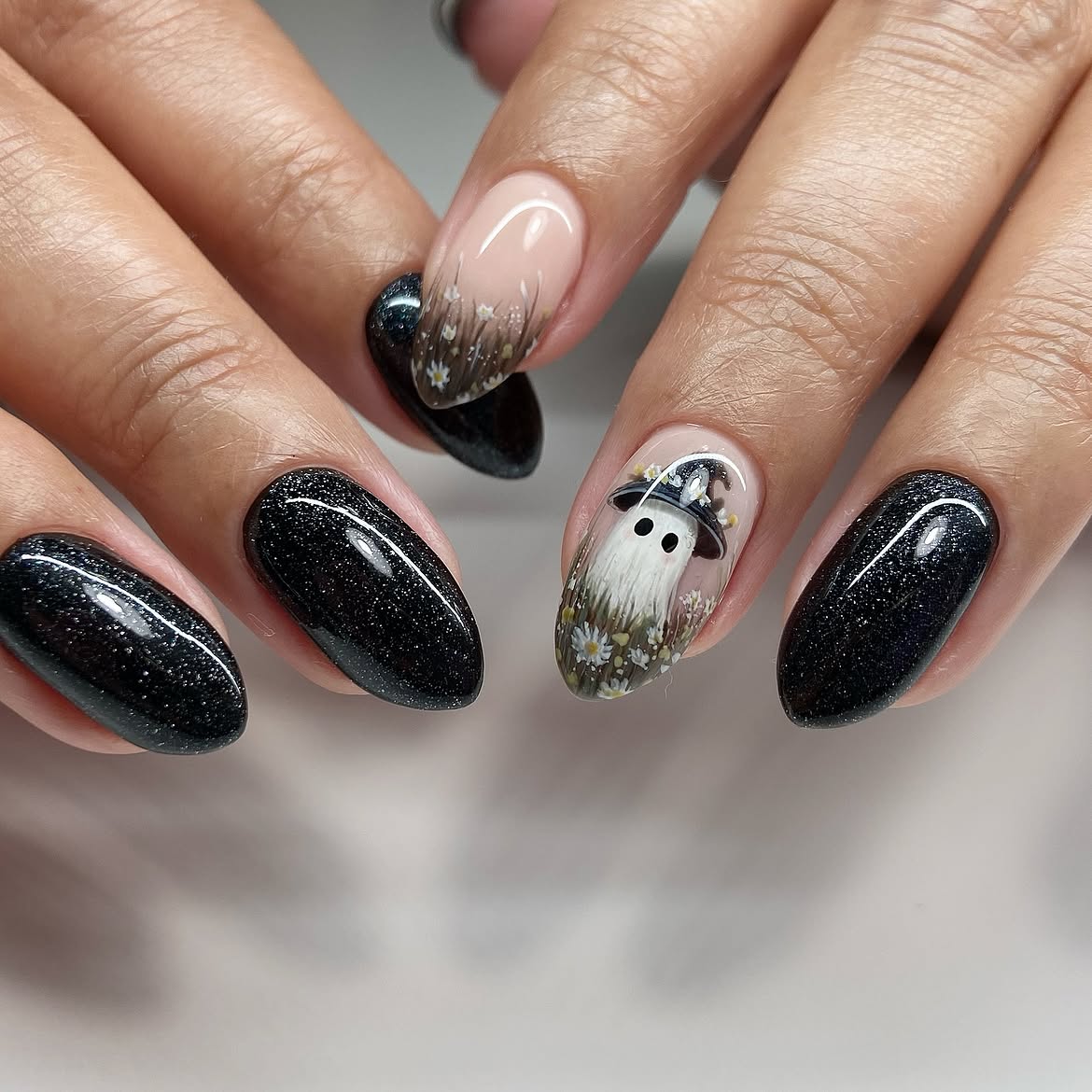 28 Spooktacular Halloween Nail Ideas You Need To Try 9 Ghostly Halloween Oval Nails with Sparkle
