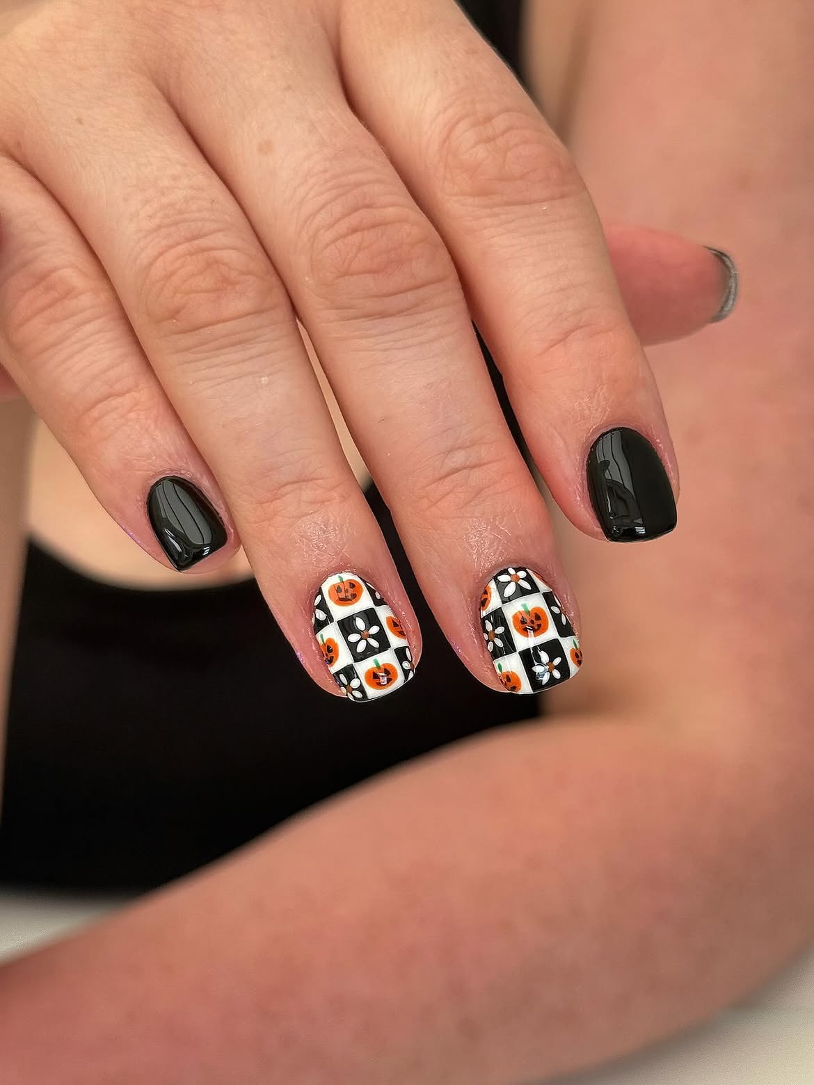 29 Spooky & Chic Halloween Nail Ideas for Short Nails 5 Ghoulish Checkerboard Pumpkin Halloween Nails