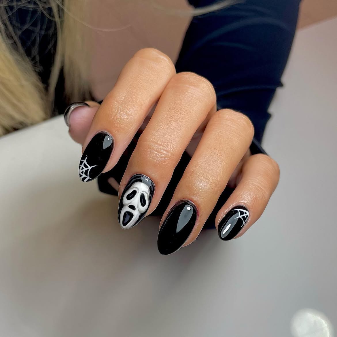 28 Spooktacular Halloween Nail Ideas You Need To Try 23 Ghoulish Ghost Face Halloween Almond Nails