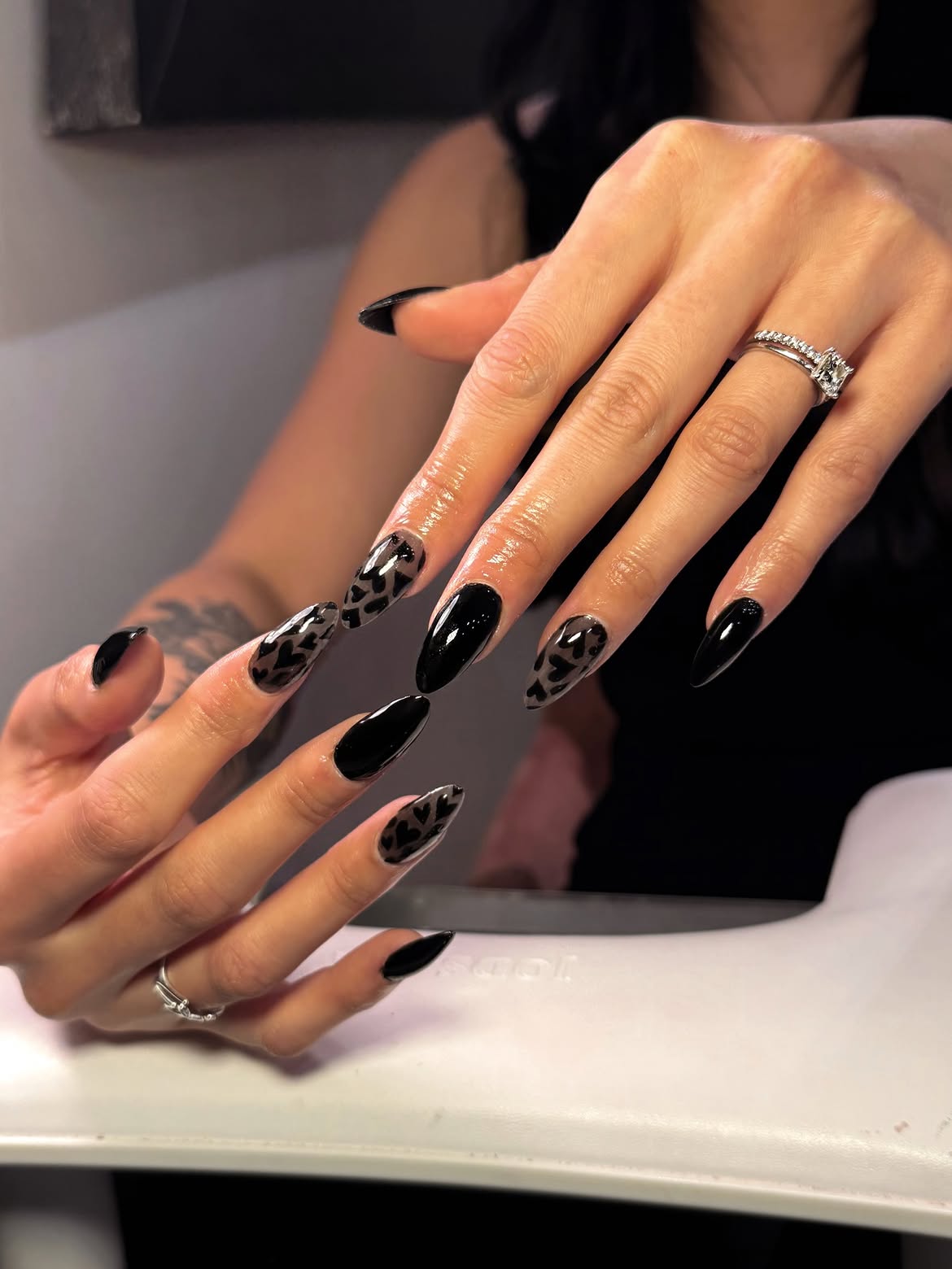 Glossy Black Stiletto Nails with Translucent Hearts