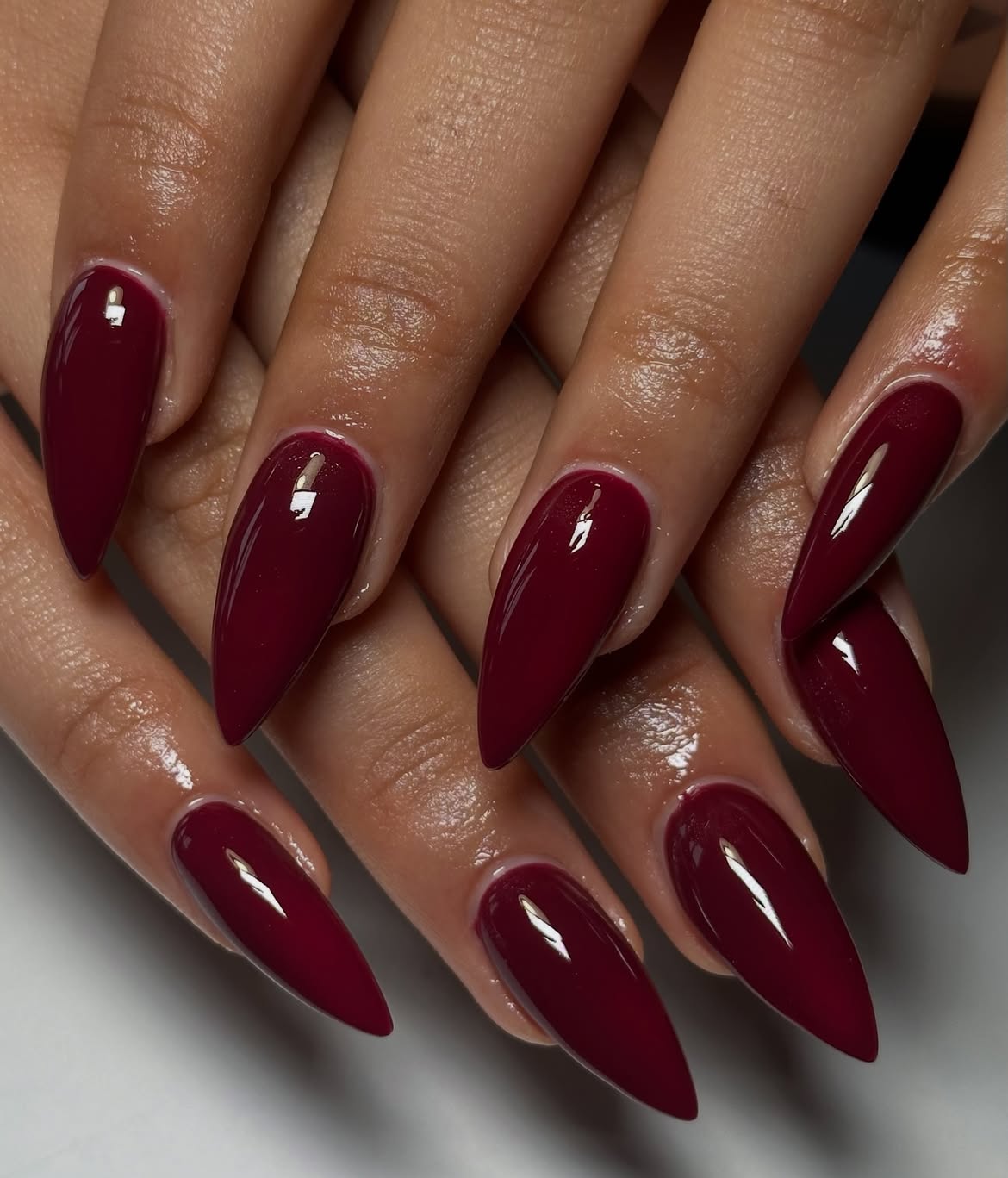 Glossy Deep Burgundy Stiletto Almond Nails