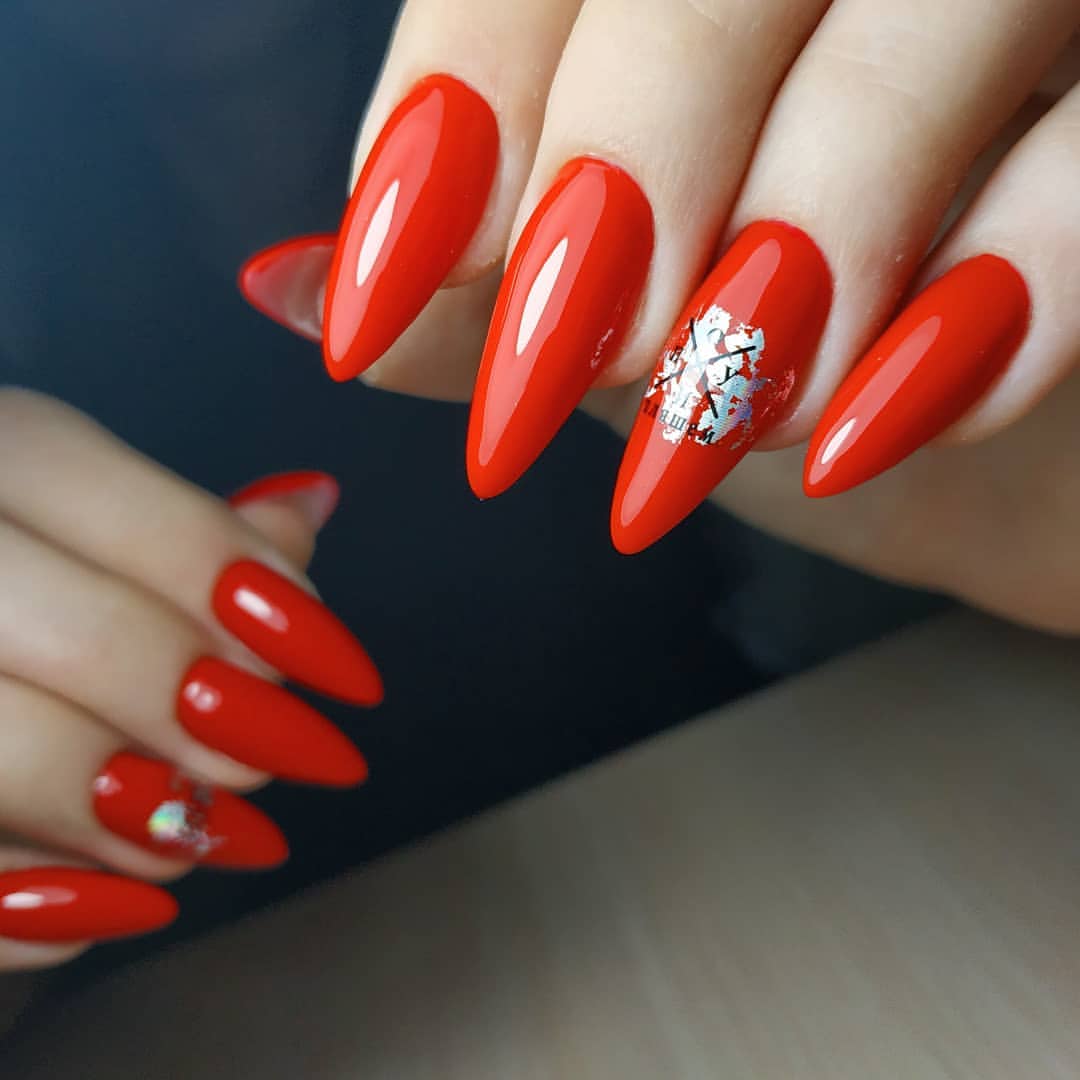 Glossy Vivid Red Stiletto Nails with Silver Foil Accents