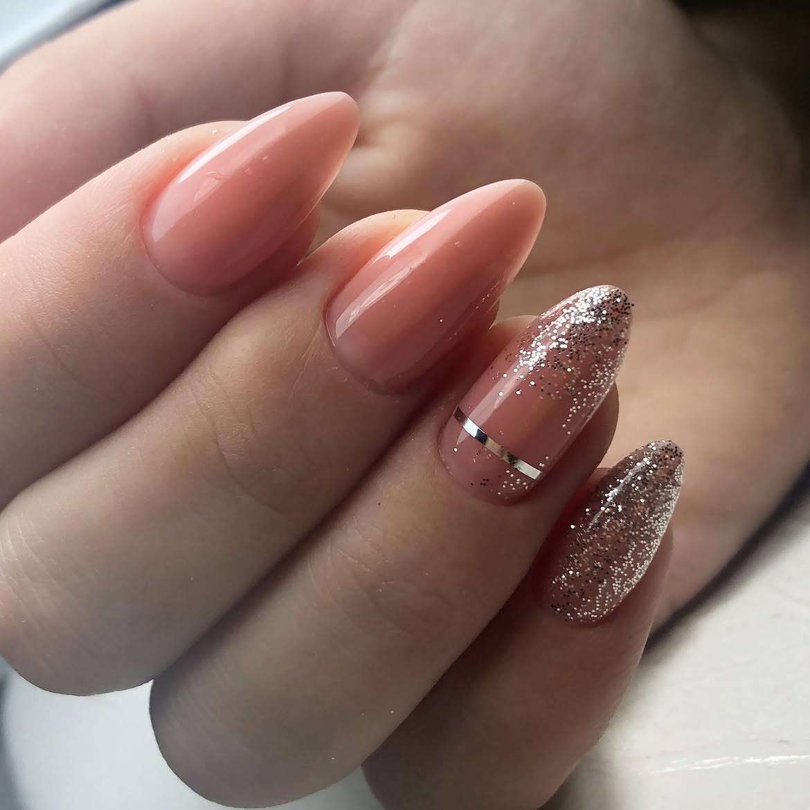 Glowy Pink Almond Nails with Silver Accents