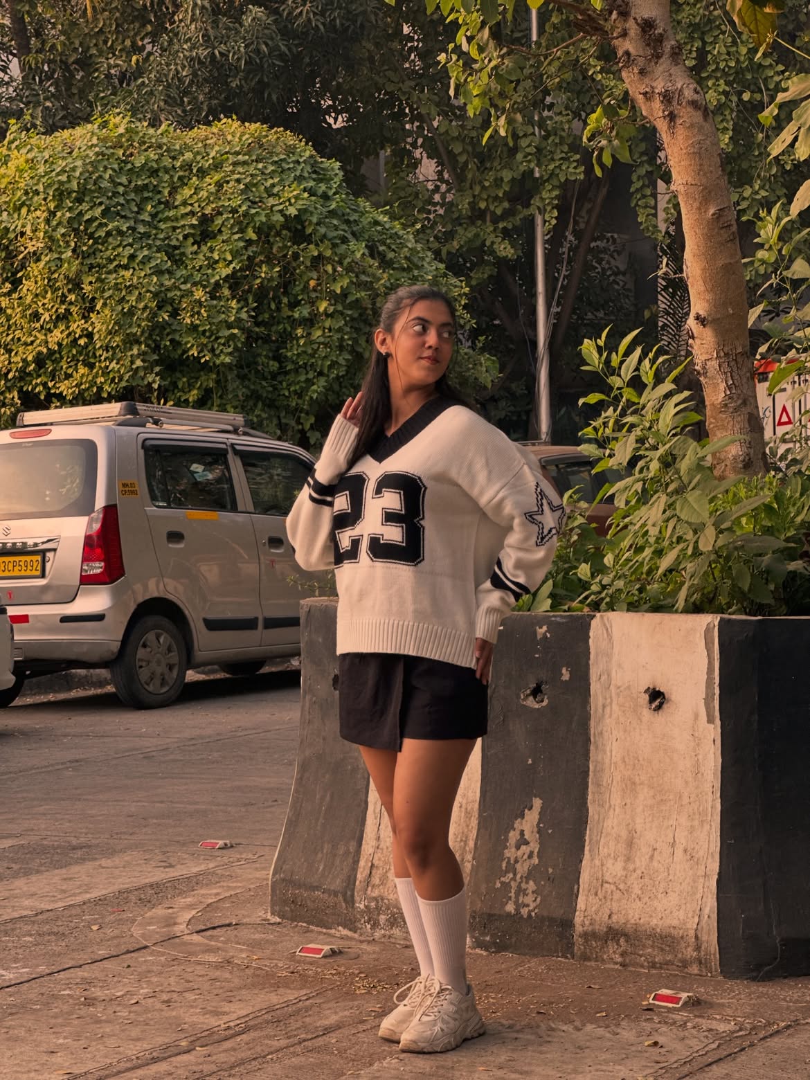 Graphic Varsity Sweater With Black Skort And Chunky Sneakers