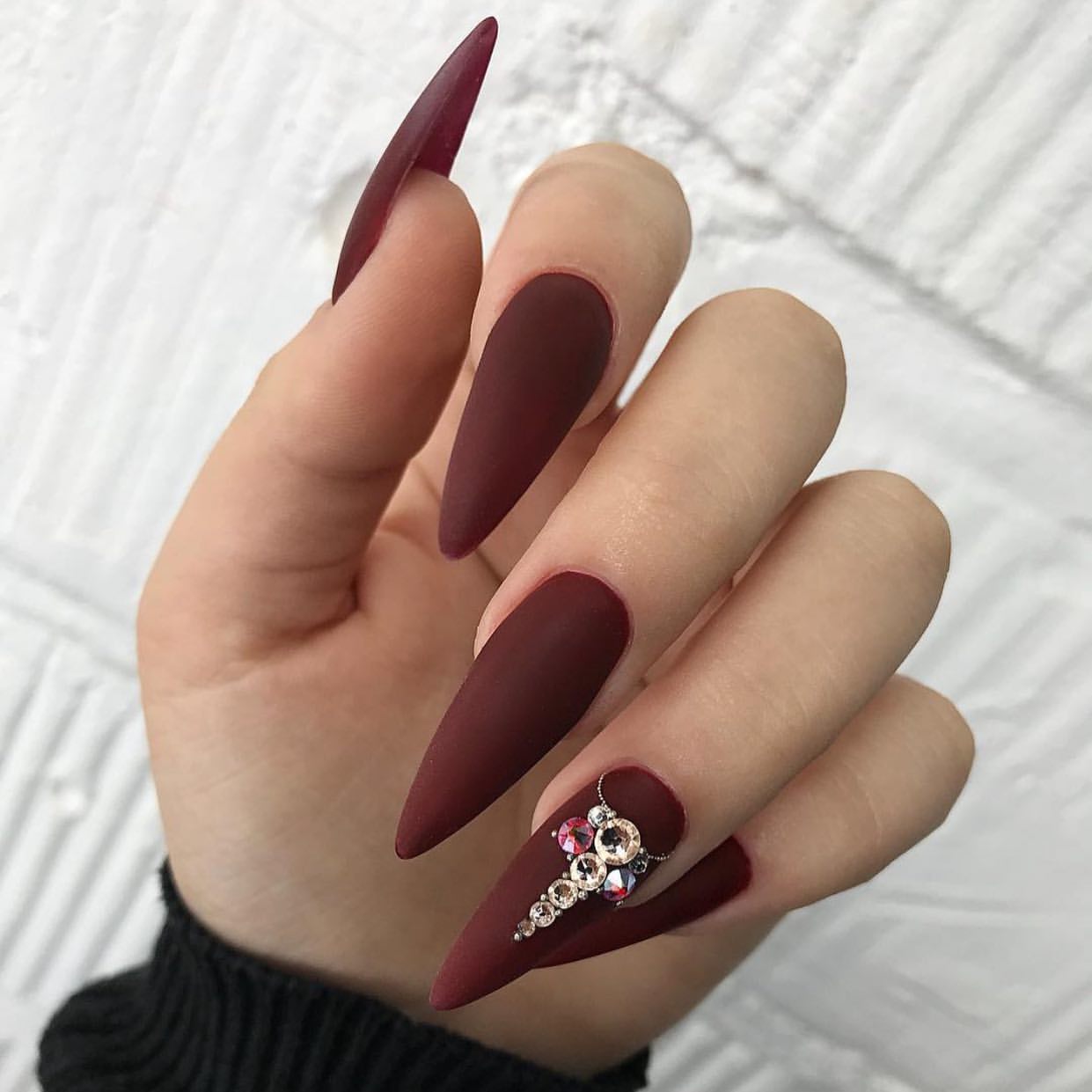 Matte Burgundy Stiletto Nails with Rhinestone Cross Accent