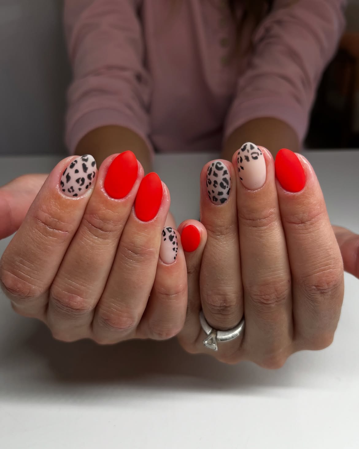 Matte Cherry Red And Cheetah Print Almond Nails