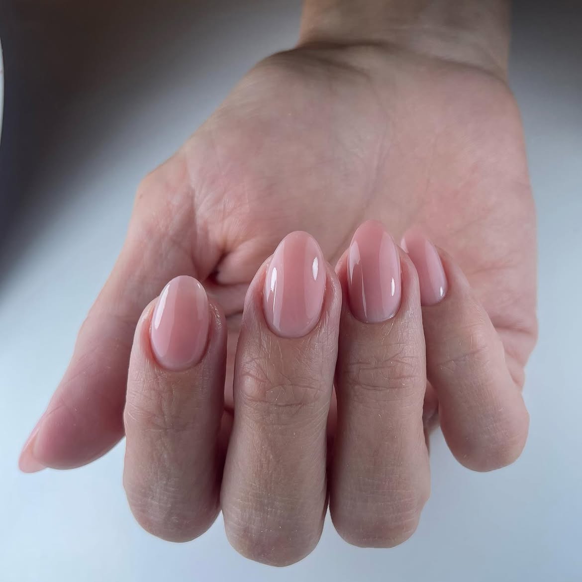 Milky Pink Oval Nails With High Gloss Finish