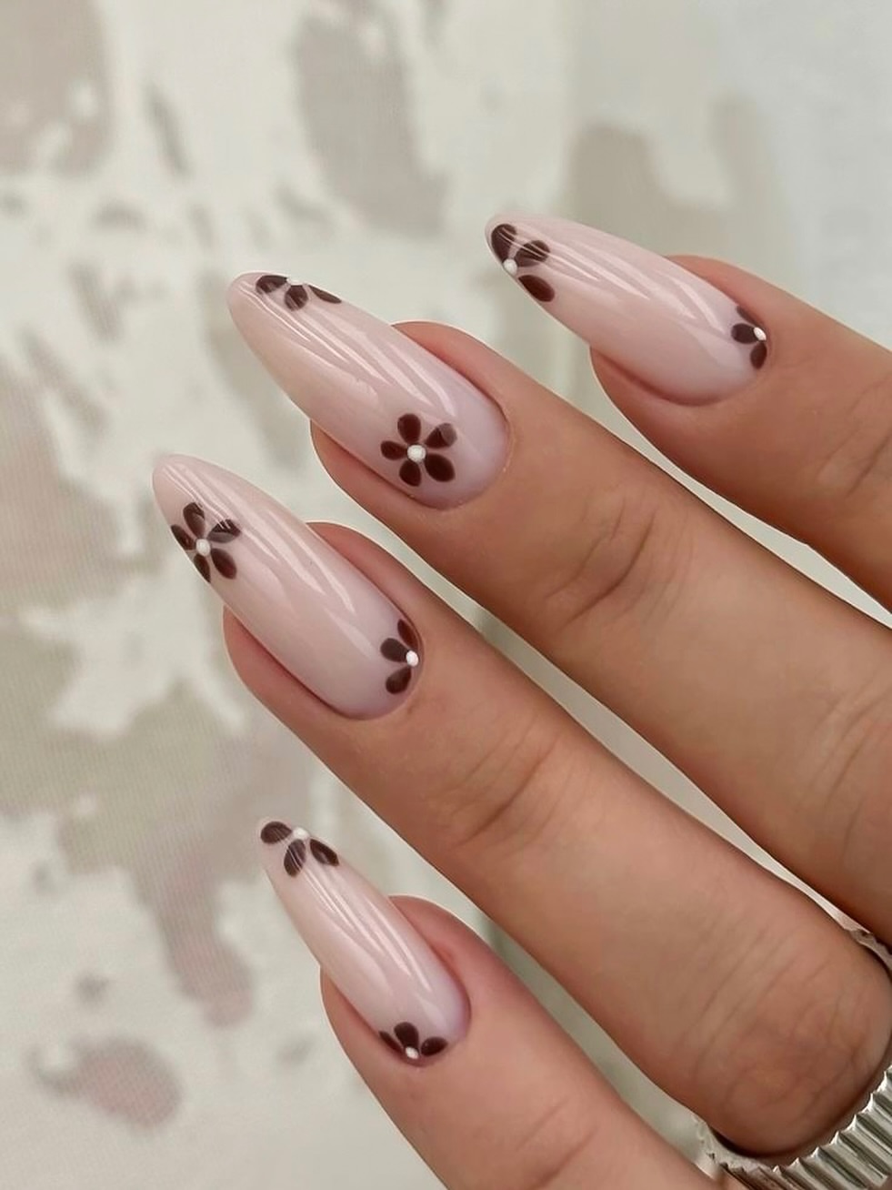 Nude Almond Nails with Delicate Dark Brown Flowers