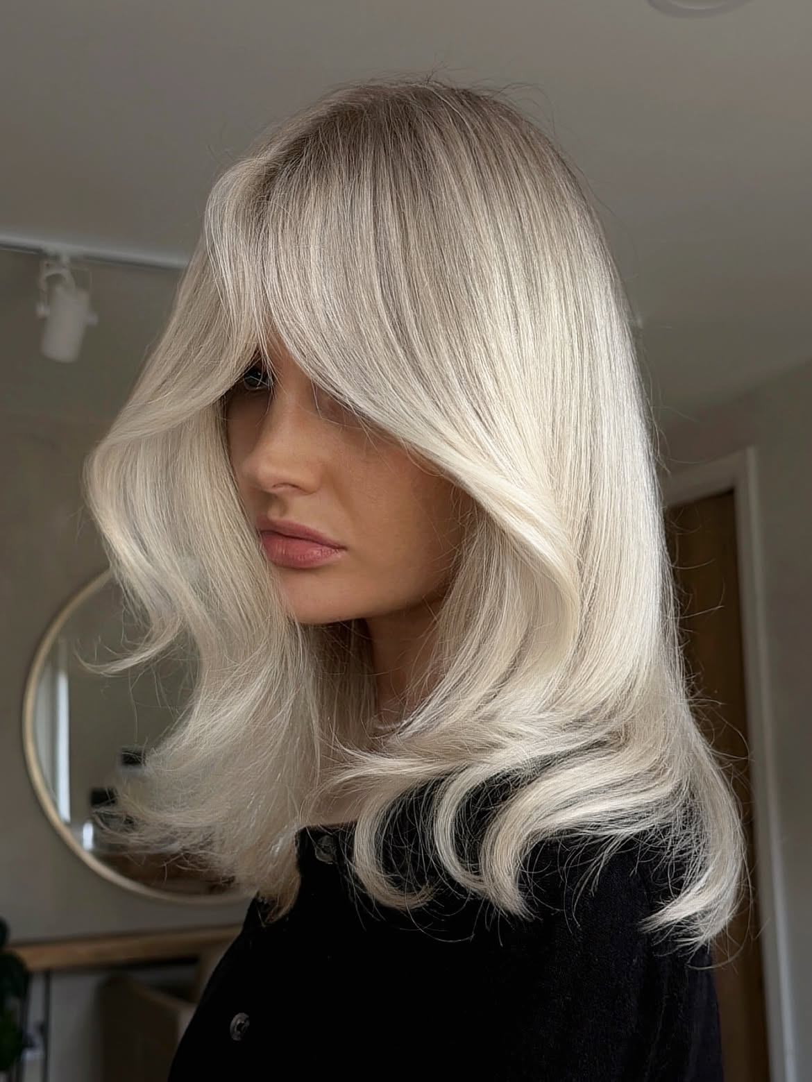 Soft Layered Platinum Blonde With Curtain Bangs