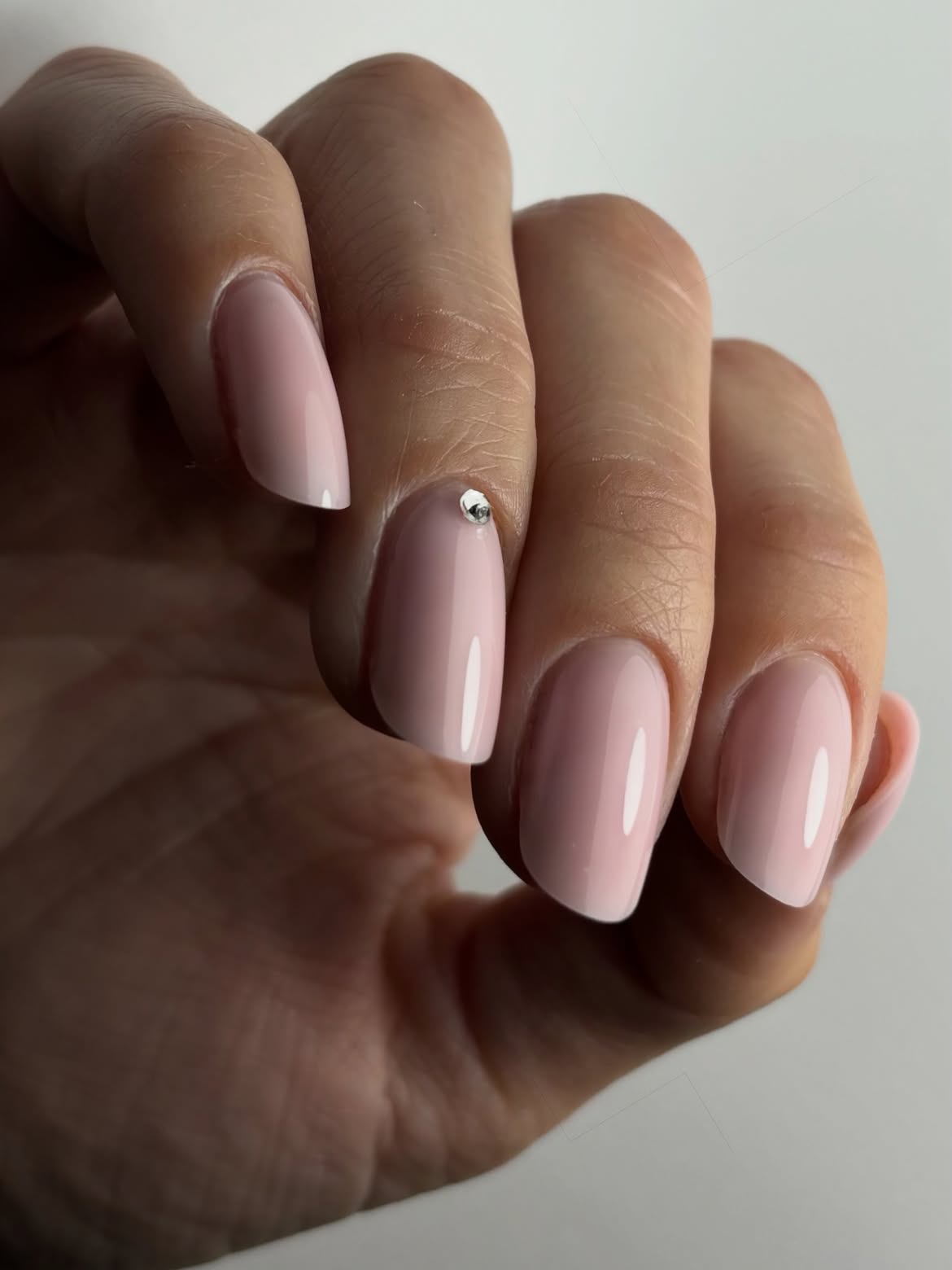 Soft Pink Oval Nails with Rhinestone Accent