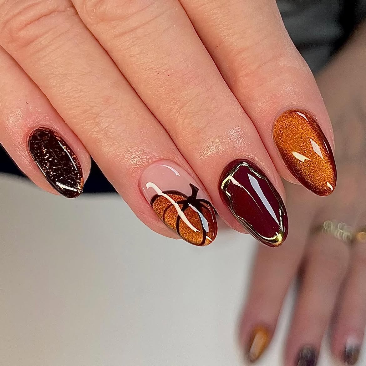 28 Stunning Pumpkin Nail Ideas for a Chic Fall Look 15 Sparkling Pumpkin and Burgundy Aura Manicure