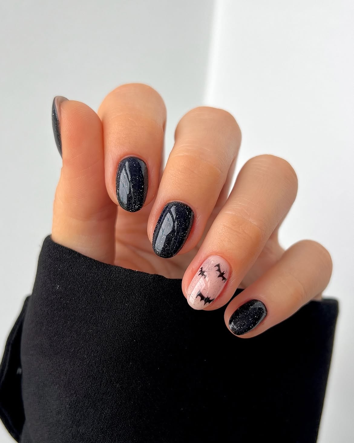 29 Spooky & Chic Halloween Nail Ideas for Short Nails 28 Sparkly Black & Bat Accent Halloween Nails