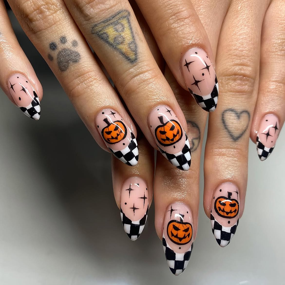 28 Stunning Pumpkin Nail Ideas for a Chic Fall Look 11 Spooky Halloween Pumpkin Checkerboard Almond Nails