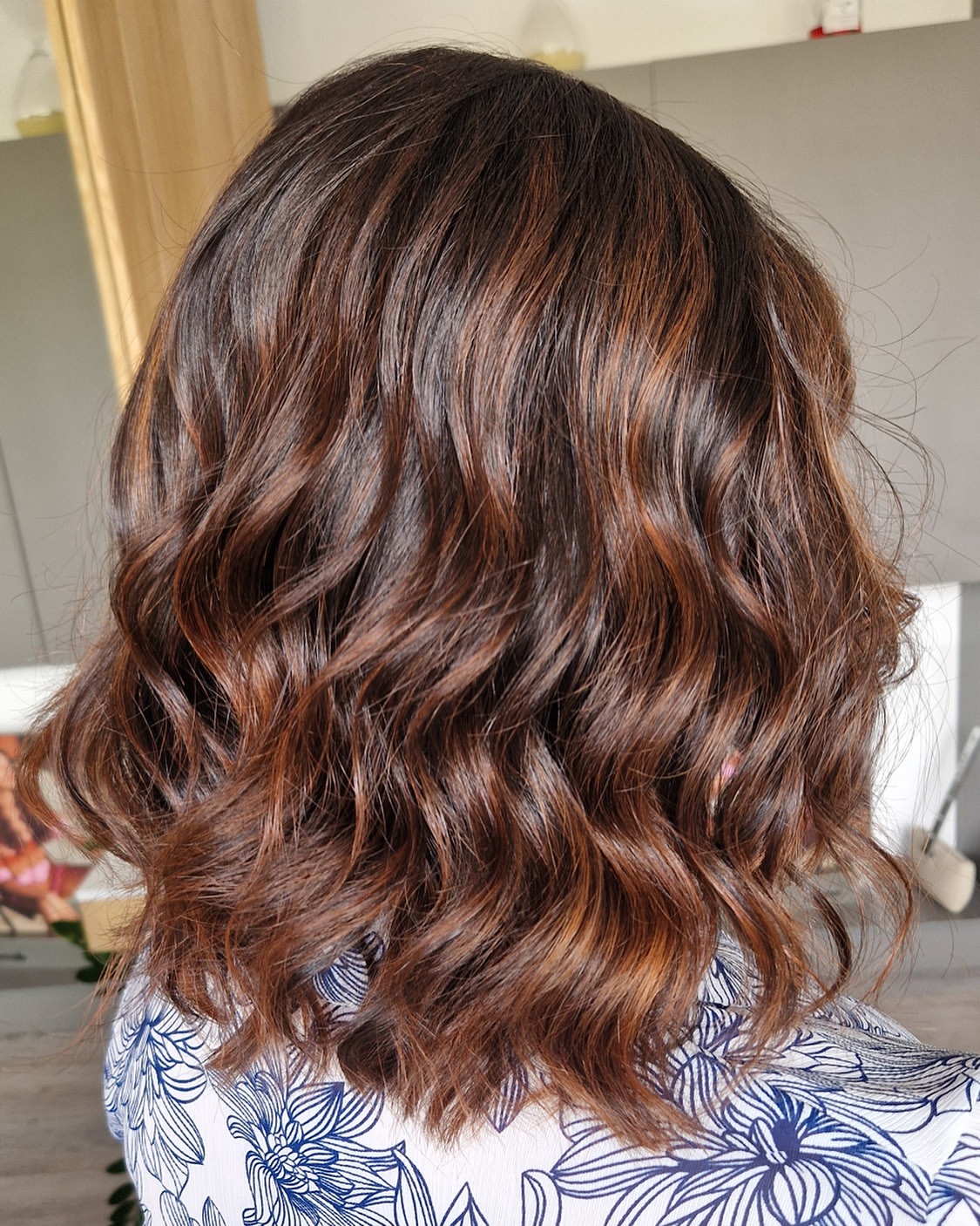 Warm Copper Highlights On Brunette Wavy Lob