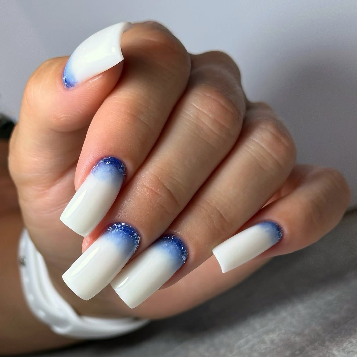 White Ombre Nails with Blue Glitter French Tips